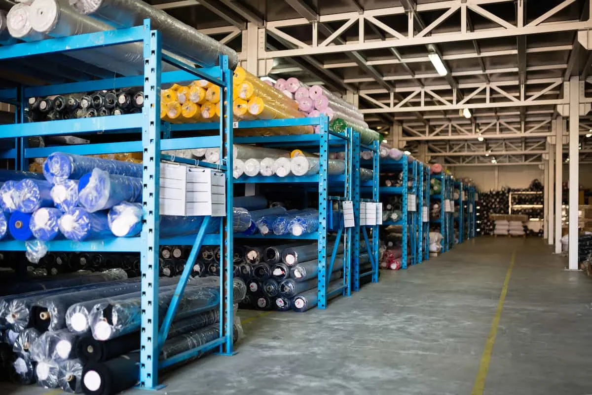 Fabric rolls stored on warehouse racking with lot labels