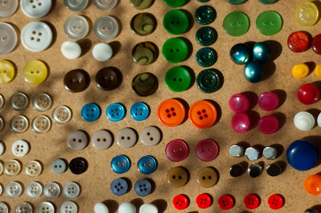 Button & Hardware — custom hospitality uniform detail close-up