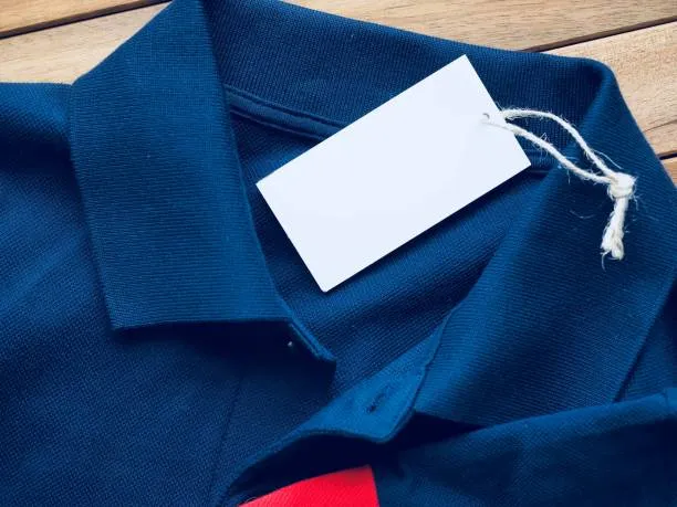 Fabric swatches, custom labels, and branding design mockups on a factory desk