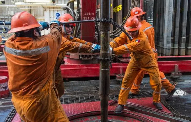 Oil and gas field workers in FR coveralls and hi-vis gear