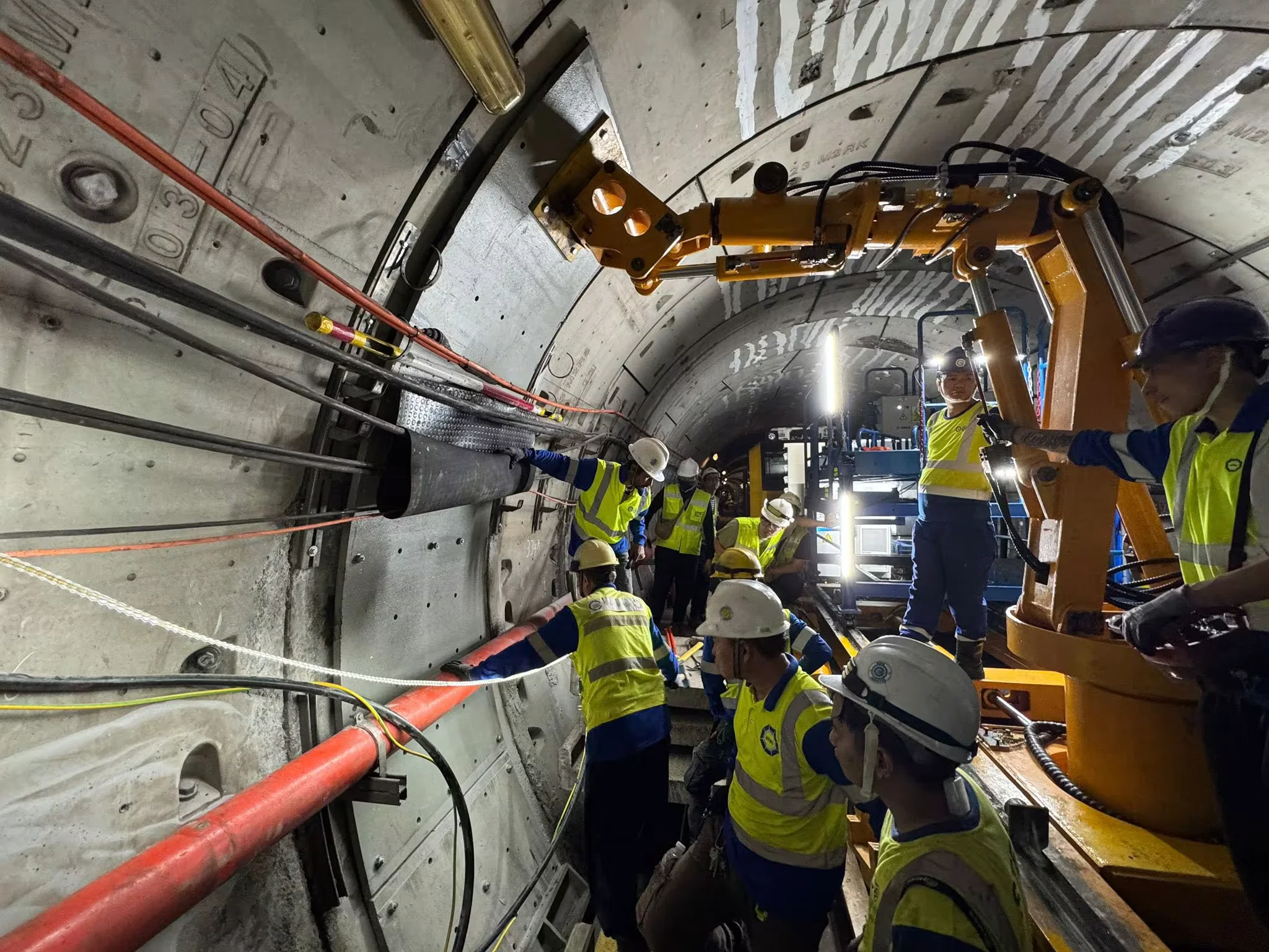 Highway tunnel construction workers in matching certified hi-vis gear