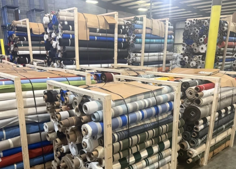 Fabric rolls with certification labels in warehouse