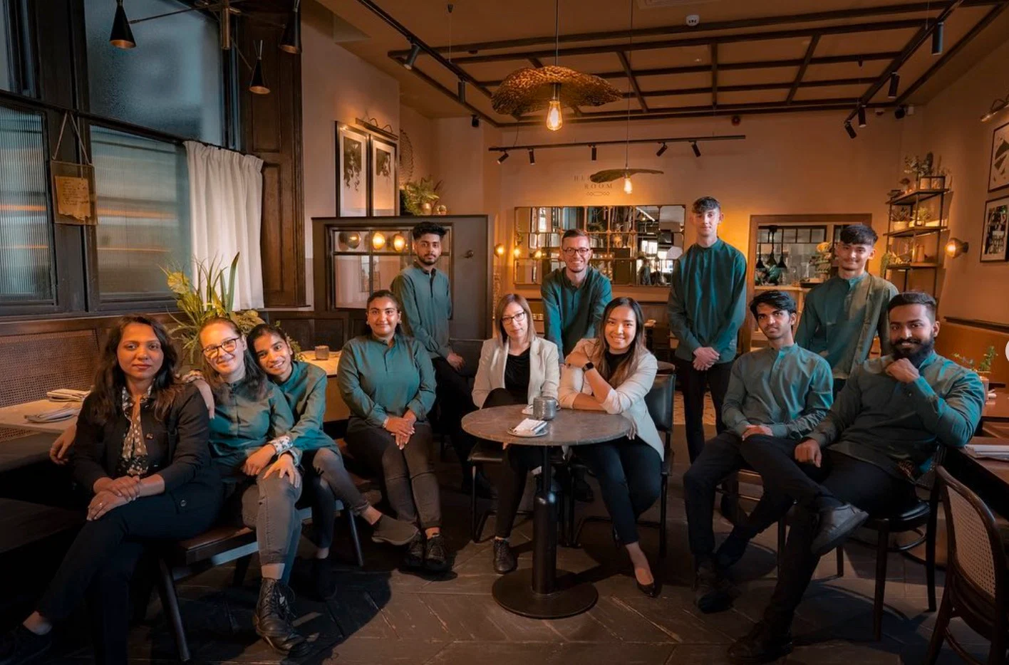 Specialty café chain kitchen staff in chef uniforms rolled out across multiple locations